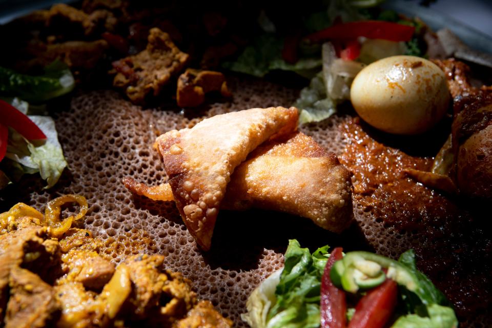 A pair of sambussas adorn the center of a sampling plate of food at Zagwe’s Restaurant in the Whiteaker neighborhood.