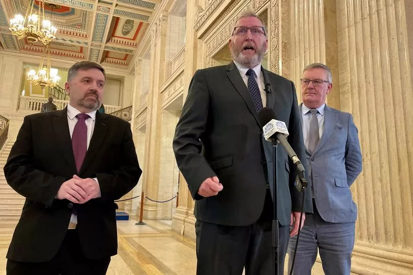 Health Minister Robin Swann (left), UUP leader Doug Beattie (centre) and UUP MLA Mike Nesbitt speak to members of the media in the Great Hall of Parliament Buildings -Credit:David Young/PA Wire