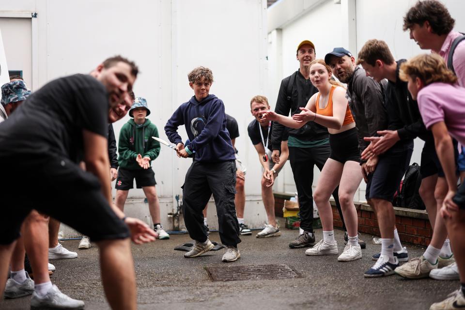 Fans continue to entertain themselves as the rain continues at Headingley (Getty Images)