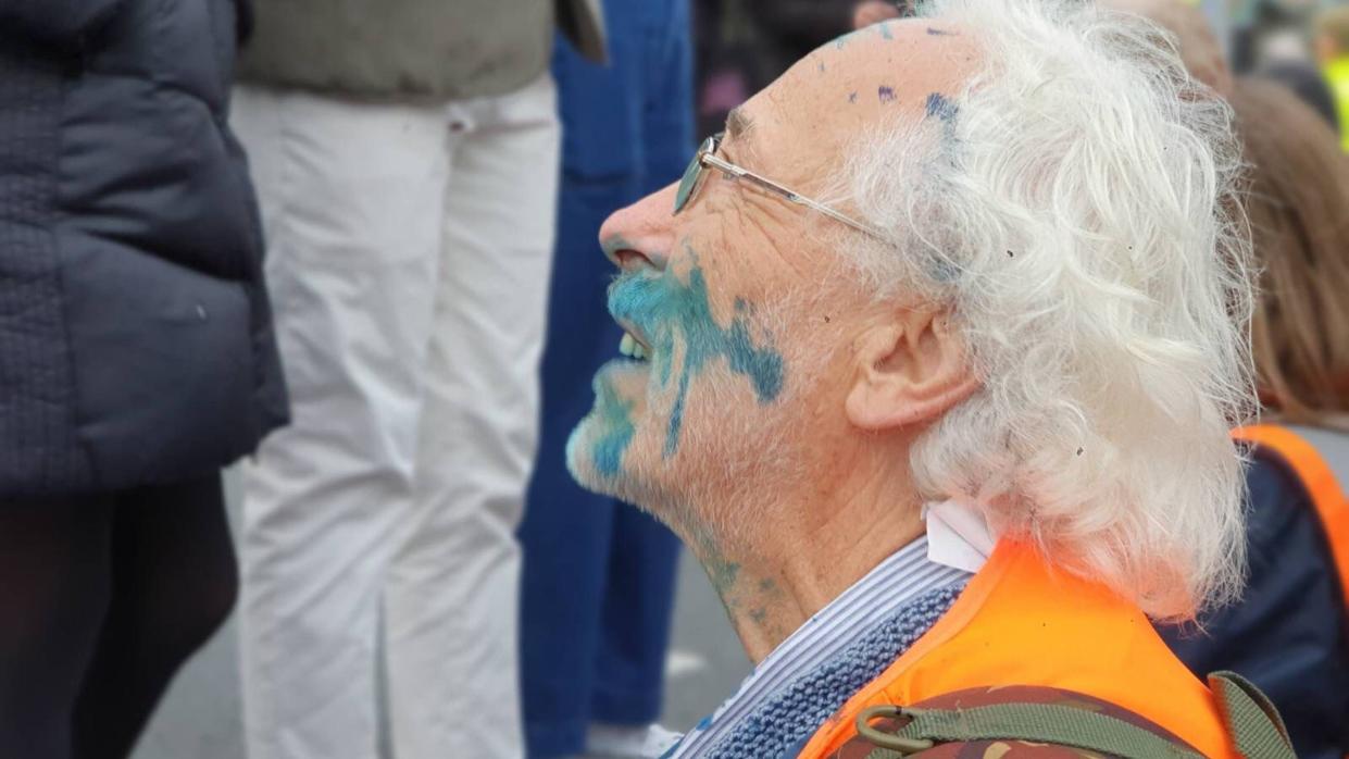 A protester is covered in ink. (PA)