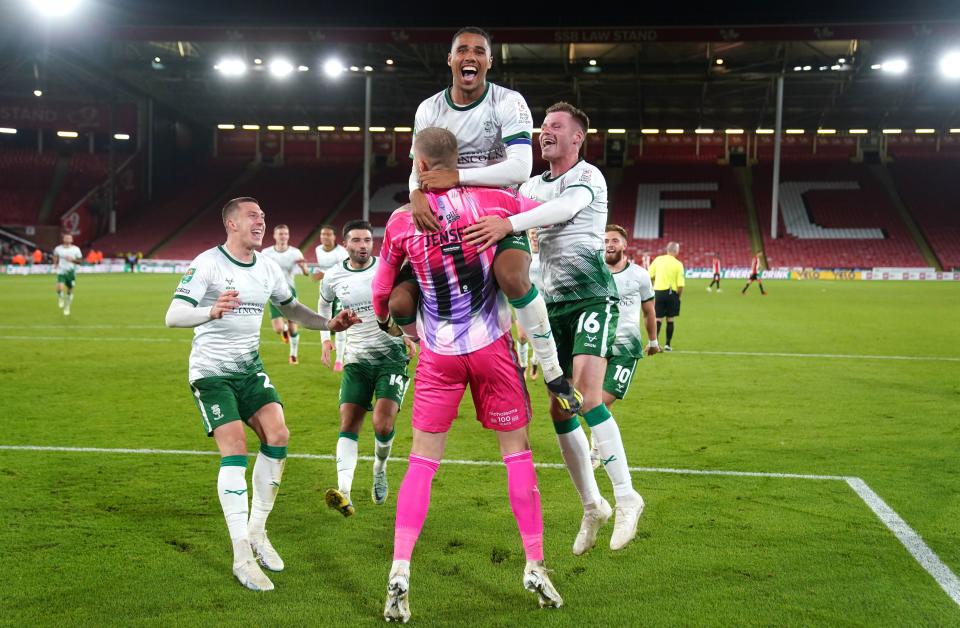 Lincoln players celebrate their victory over Sheffield United (PA)