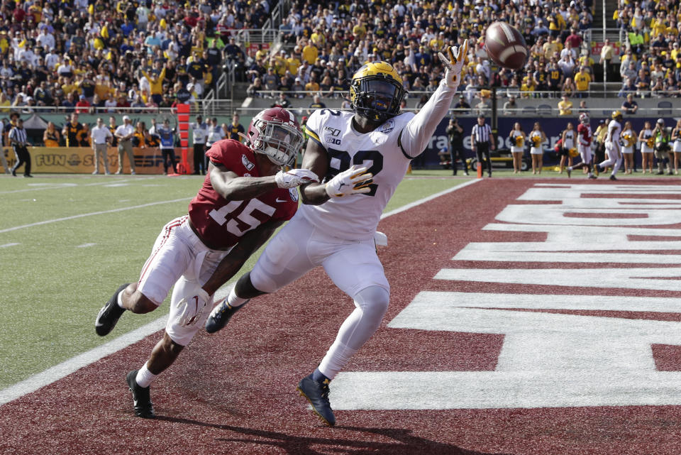 FILE - In this Jan. 1, 2020, file photo, Alabama defensive back Xavier McKinney (15) breaks up a pass intended for Michigan tight end Nick Eubanks during the first half of the Citrus Bowl NCAA college football game in Orlando, Fla. McKinney was chosen by the New York Giants in the second round of the NFL football draft Friday, April 24, 2020. (AP Photo/John Raoux, File)