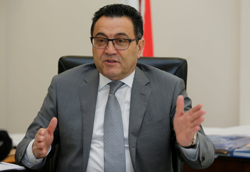 FILE PHOTO: Nadim Munla, Lebanese PM's senior adviser, gestures as he speaks during an interview with Reuters in Beirut