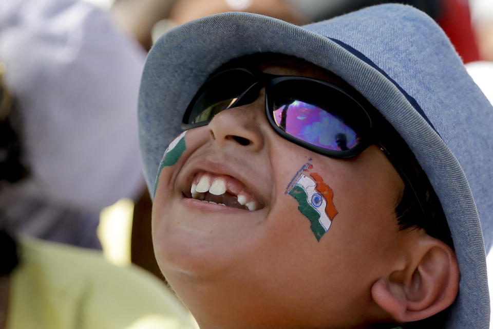 A boy cheers for India during day three of the second Test cricket match between India and and West Indies at Sabina Park cricket ground in Kingston, Jamaica Sunday, Sept. 1, 2019. (AP Photo/Ricardo Mazalan)