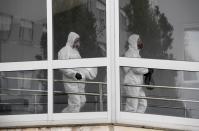 Members of the Military Emergency Unit (UME) take part in a clean-up to prevent the spread of the coronavirus disease (COVID-19) at Cabuenes Hospital in Gijon