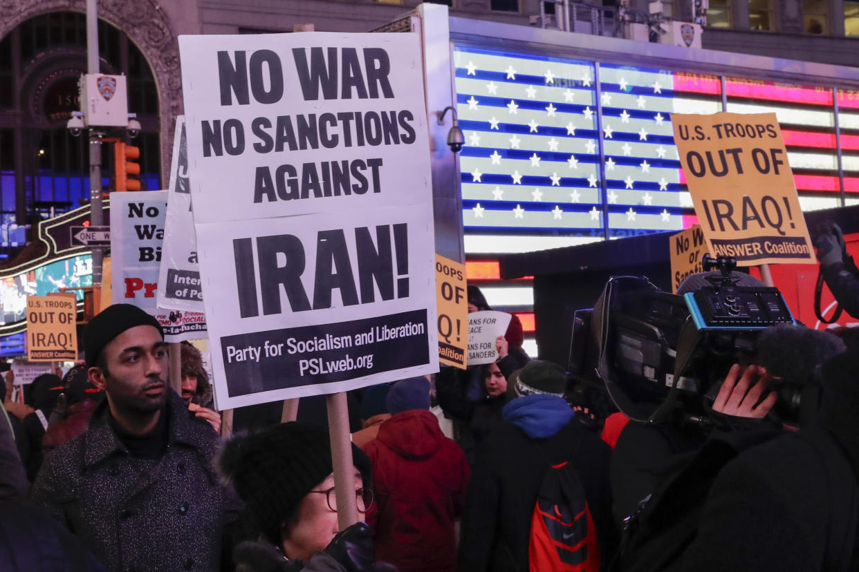 Protesters gather in Times Square Wednesday, Jan. 8, 2020, in New York. The U.S. and Iran stepped back from the brink of possible war Wednesday, as President Donald Trump indicated he would not respond militarily after no one was harmed in Iran's missile strike on two Iraqi bases housing U.S. troops. (AP Photo/Frank Franklin II)