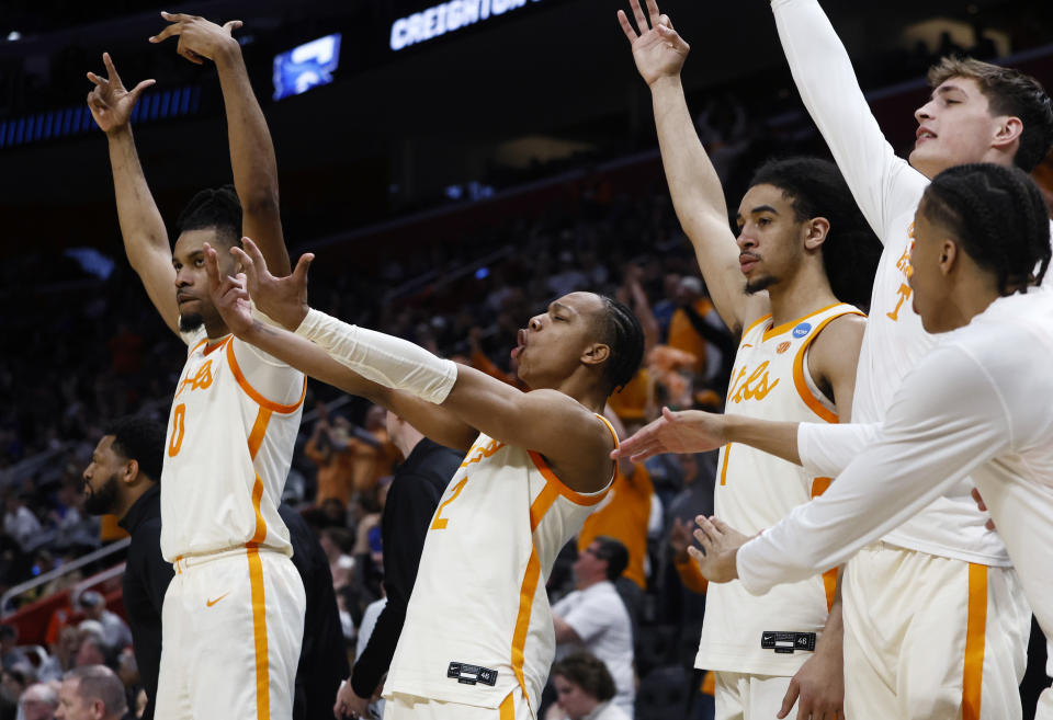 Tennessee players react after a teammate's three-point basket during the second half of a Sweet 16 college basketball game against Creighton in the NCAA Tournament, Friday, March 29, 2024, in Detroit. (AP Photo/Duane Burleson)