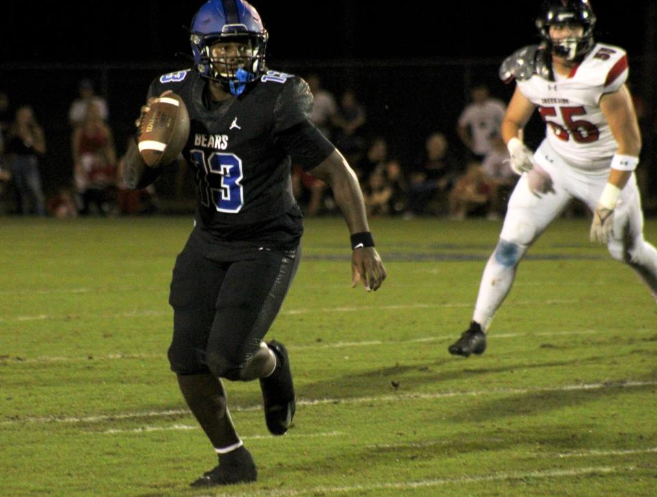 Bartram Trail quarterback Jaden Weatherly (13) rushes for yardage against Creekside in a 2023 game.