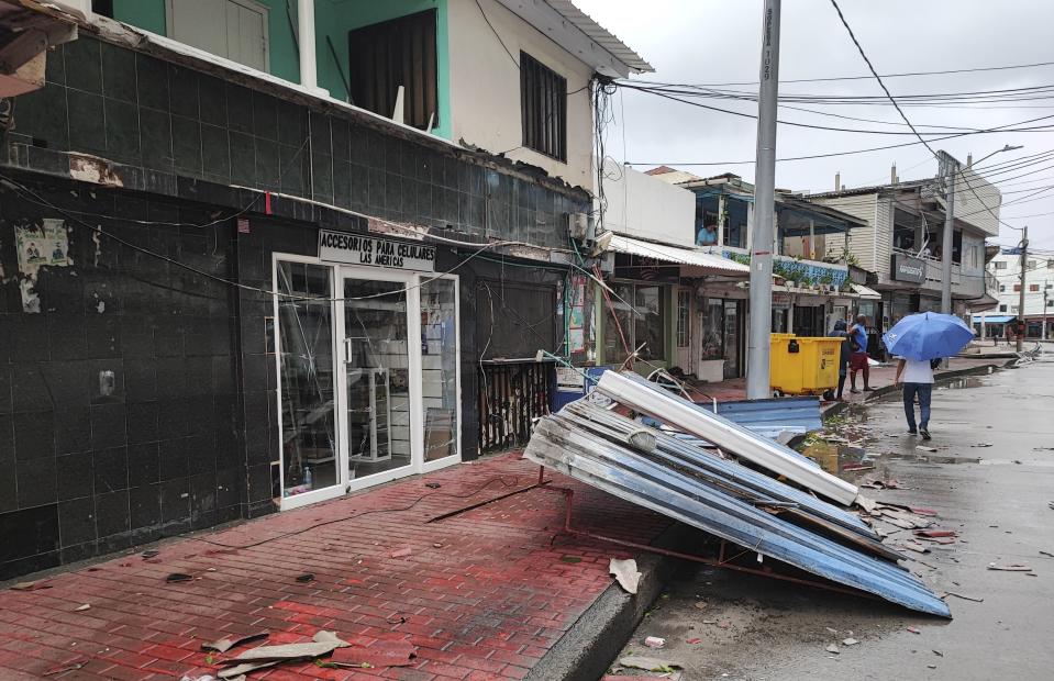 People walk past a damaged house in the aftermath of Hurricane Julia in San Andres island, Colombia, Sunday, Oct.9, 2022. Hurricane Julia hit Nicaragua’s central Caribbean coast on Sunday after lashing Colombia’s San Andres island, and a weakened storm was expected to emerge over the Pacific. (AP Photo/Daniel Parra)