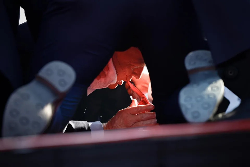 PHOTO: Secret Service members tend to republican presidential candidate former President Donald Trump onstage after he was grazed by a bullet at a rally on July 13, 2024.  (Anna Moneymaker/Getty Images)