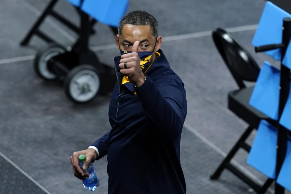 Michigan head coach Juwan Howard celebrates as he walks off the court after a Sweet 16 game against Florida State in the NCAA men's college basketball tournament at Bankers Life Fieldhouse, Sunday, March 28, 2021, in Indianapolis. Michigan won 76-58. (AP Photo/Darron Cummings)