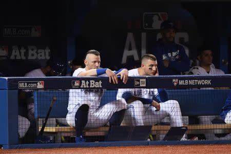 Oct 17, 2016; Toronto, Ontario, CAN; Toronto Blue Jays third baseman Josh Donaldson (left) and shortstop Troy Tulowitzki (right) watch from the dugout during the ninth inning in game three of the 2016 ALCS playoff baseball series against the Cleveland Indians at Rogers Centre. Mandatory Credit: Nick Turchiaro-USA TODAY Sports