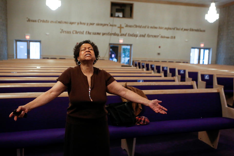 Loretta Johnson prays at the Faith Temple Church in the Fifth Ward, known as the historic Black community, in Evanston, Ill.