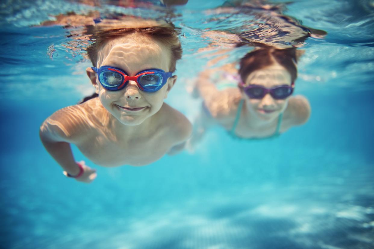 two kids swimming in pool