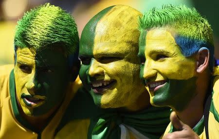 Fans brasileños fotografiados antes del inicio del partido entre Chile y Brasil ad portas a los octavos de final por la Copa del Mundo, en el Estadio Mineriao, en Belo Horizonte, 28 de junio de 2014. REUTERS/Dylan Martinez