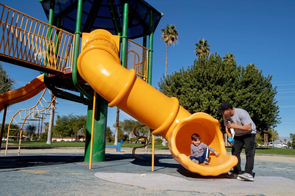 John Hernandez of Cathedral City plays with his son, Gabe, 4, at a playground at Dumuth Park in Palm Springs, Calif., on Saturday, Dec. 5, 2020.