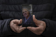 In this Wednesday, May 13, 2020 photo, Andres Campos shows a picture of her mother in law Carmen Lopez, 84, in Madrid, Spain. Carmen Lopez was one of the residents at the Usera Center for the Elderly, who died during the coronavirus outbreak in Spain. More than 19,000 coronavirus deaths in Spain's nursing homes have prompted a re-examination of a system in which public nursing homes are often controlled by private-equity firms. (AP Photo/Bernat Armangue)