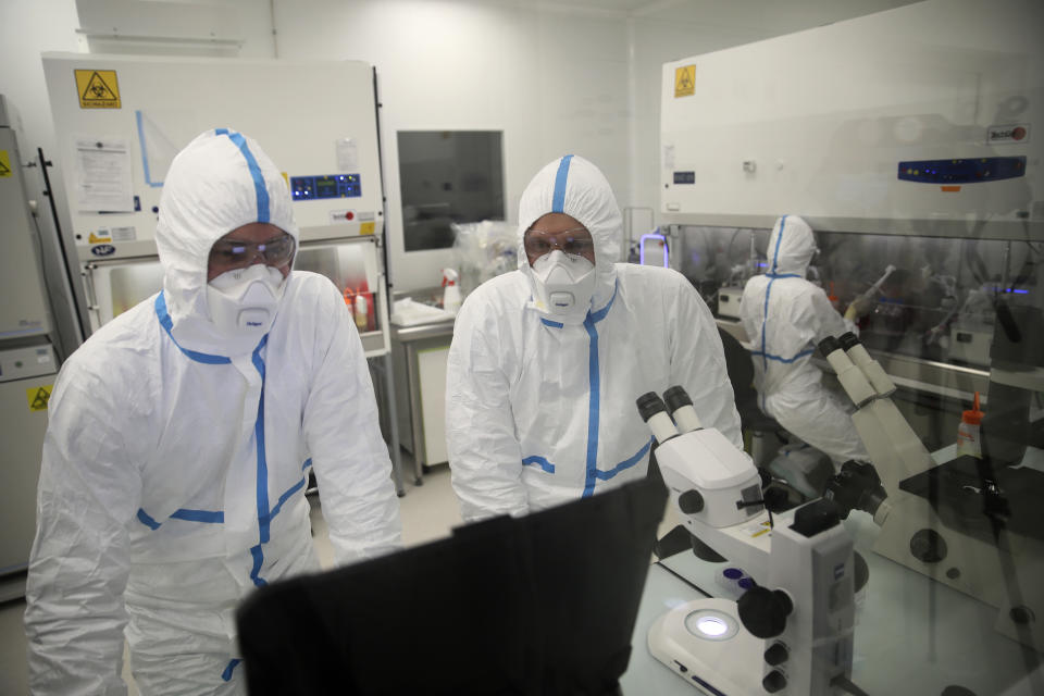 Laboratory technicians work at Valneva headquarters in Saint-Herblain, western France, Wednesday, Feb. 3, 2021. French pharmaceutical startup Valneva had big news in September: a government contract for 60 million doses of its coronavirus vaccine candidate. The buyer? The United Kingdom — not the European Union, as might be expected for a company on the banks of the Loire. (AP Photo/David Vincent)