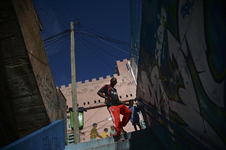 'Bino', guide and resident of the Cova da Moura neighborhood of Amadora, on the outskirts of Lisbon, waits for tourists outside the NGO 'Moinho da Juventude', on October 23, 2014