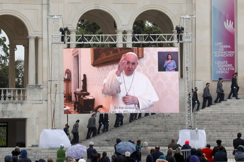 Pilgrims attend the 104th anniversary of the appearance of the Virgin Mary at the Catholic shrine of Fatima