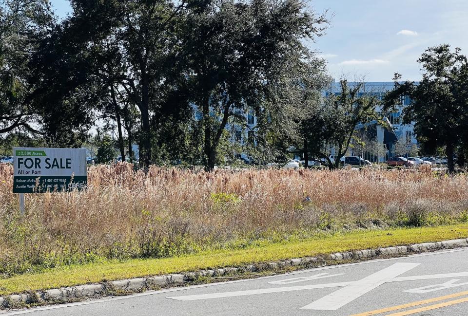 A "For Sale" sign can still be seen for Ormond Crossings in Ormond Beach on Tuesday, Jan. 2, 2024. The nearly 3,000 acre mixed-use development site south of U.S. Highway 1 on both sides of Interstate 95 was sold on Dec. 5, 2023 for $62 million to developer Bradford Kline. The sale did not include the 48-acre headquarters campus for Security First Insurance (visible in the distance).