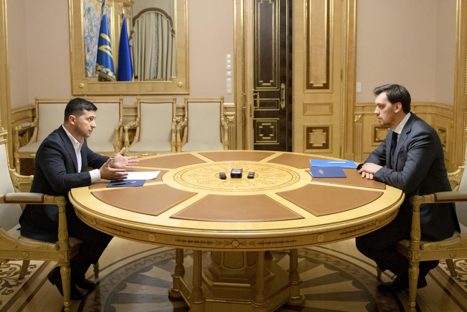 In this photo provided by the Ukrainian Presidential Press Office, Ukrainian President Volodymyr Zelenskiy, left, talks with Ukraine's Prime Minister Oleksiy Honcharuk in Kyiv, Ukraine, Friday, Jan.17, 2020. Honcharuk earlier submitted his resignation to parliament following a leaked audio recording which suggested he had criticised the president. (Ukrainian Presidential Press Office via AP)