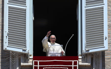 FILE PHOTO: Pope Francis waves during his Angelus prayer on the Solemnity of the Assumption of the Blessed Virgin Mary in Saint Peter's Square at the Vatican, August 15, 2017. REUTERS/Alessandro Bianchi