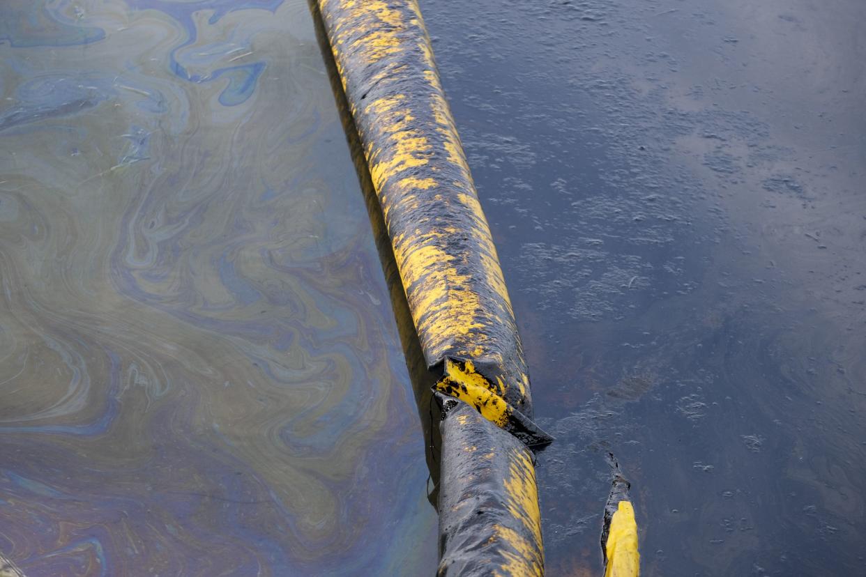 Oil floats on the water surface in the Wetlands Talbert Marsh after an oil spill in Huntington Beach, Calif. on Monday, Oct. 4, 2021.