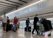 Passengers from international flights arrive at Heathrow Airport, following the outbreak of the coronavirus disease (COVID-19), London, Britain