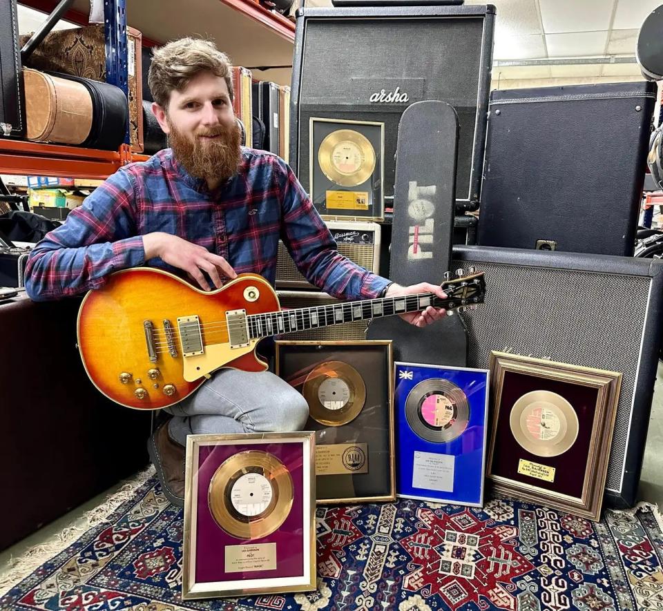 Auctioneer Luke Hobbs with Ian Bairnson's guitar gear