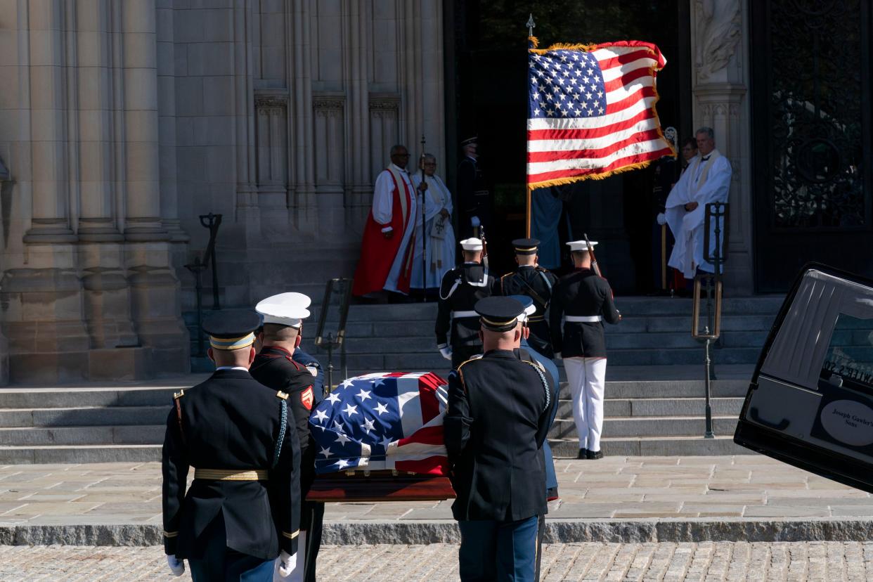 The flag-draped casket of former Secretary of State Colin Powell is carried into the Washington National Cathedral for a funeral service. 
