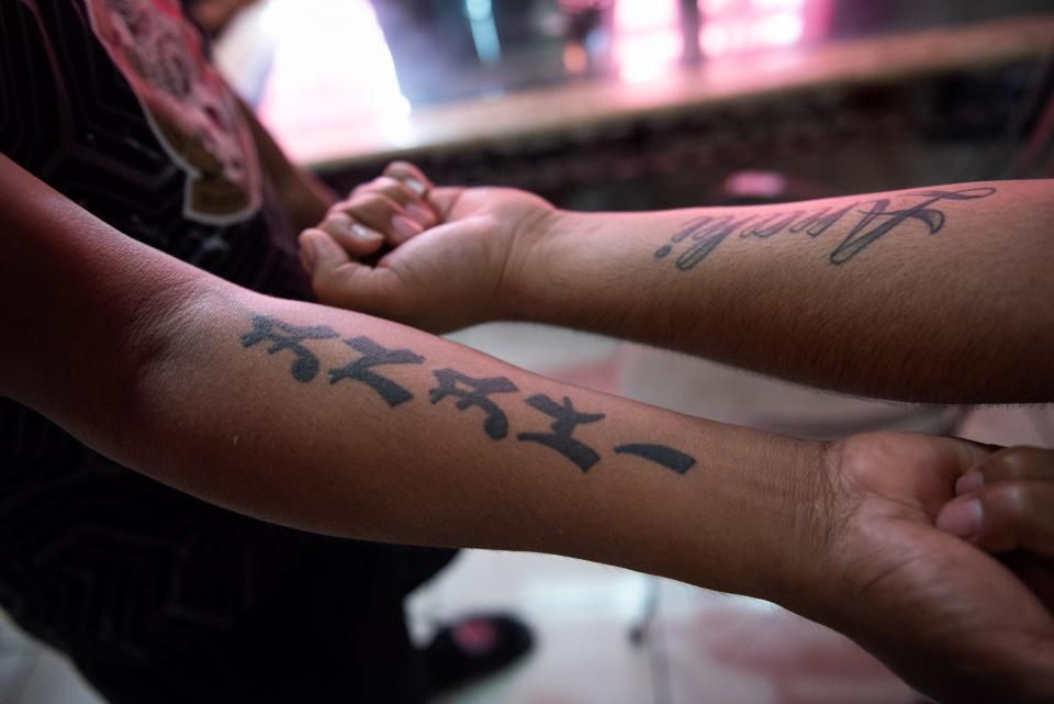 Manuel Del La Cruz, South Bay, and his son, Manuel, display their tattoos reading "Anahi," - the name of the family's 17-year-old daughter - at the home of the elder Manuel De La Cruz on Tuesday, November 1, 2022, in South Bay, FL. Manuel Sr. is the sole provider for his family, which includes a special needs child in Anahi, who has Down's syndrome. After losing two fingers during an accident while working, Manuel has had trouble finding steady work.