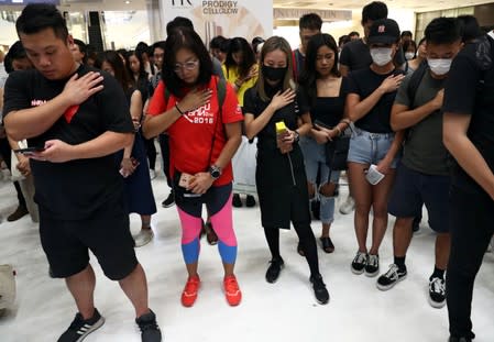 People attend a protest at New Town Plaza shopping mall in Hong Kong