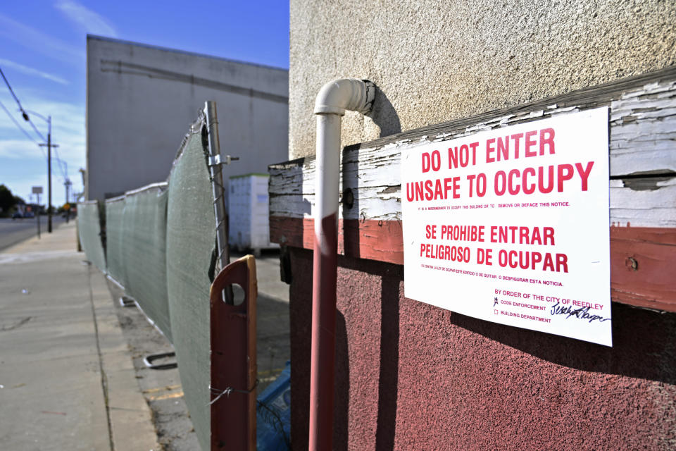 An official sign informs the public of the closure of a warehouse that housed a now-shuttered medical lab owned by Chinese business people and that officials say was operating illegally in Reedley, Calif., on July 31, 2023. (Eric Paul Zamora/The Fresno Bee via AP)