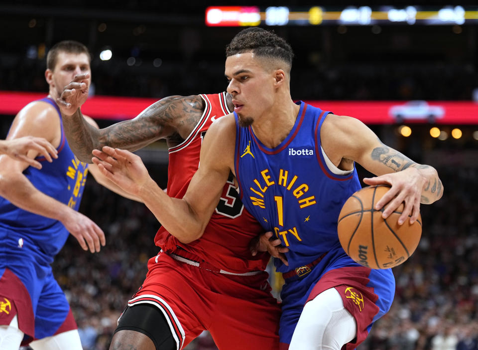 Denver Nuggets forward Michael Porter Jr. (1) drives to the basket against Chicago Bulls center Andre Drummond (3) during the second quarter of an NBA basketball game Saturday, Nov. 4, 2023, in Denver. (AP Photo/Jack Dempsey)