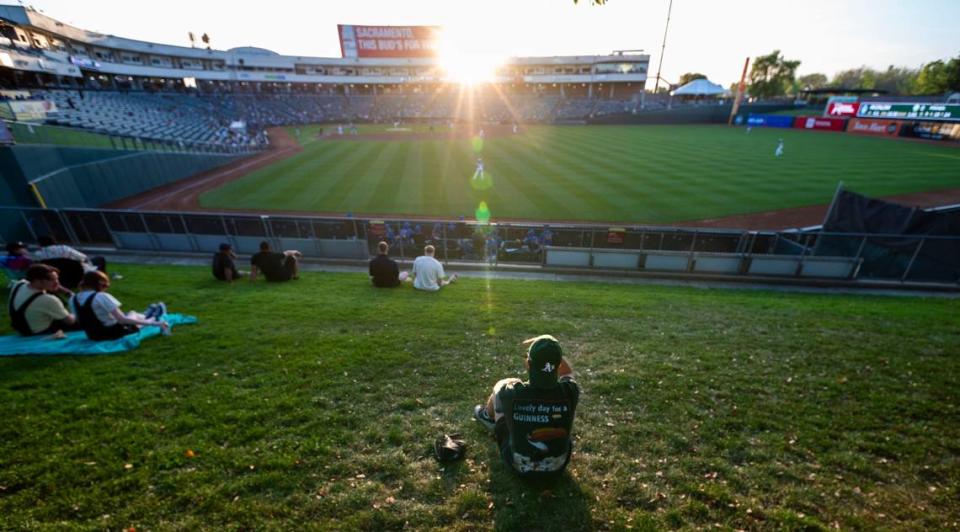 An Oakland A’s fan watches a Sacramento River Cats game Tuesday at Sutter Health Park.