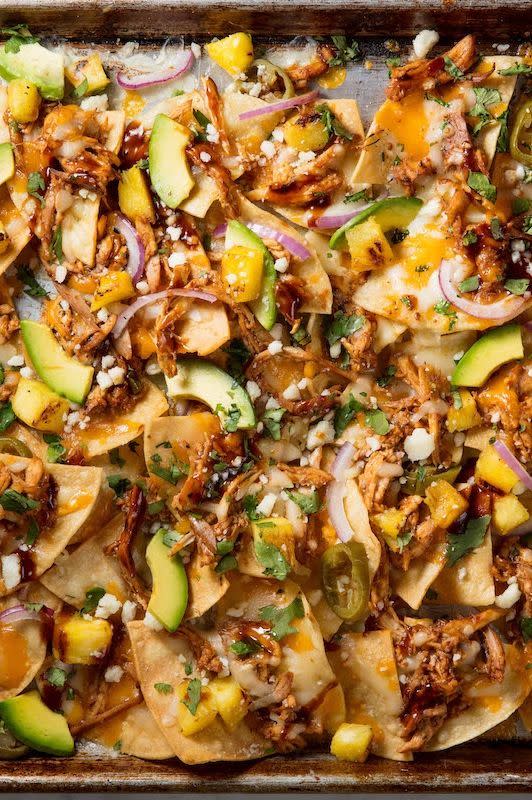 <p>When you fancy nachos, you want something quick and easy — and CHEESY. So give the people what they really want. This twist on nachos comes together in less than 30 minutes and is sure to be a crowd-pleaser. </p><p>Get the <a href="https://www.delish.com/uk/cooking/recipes/a32399492/bbq-chicken-nachos-recipe/" rel="nofollow noopener" target="_blank" data-ylk="slk:BBQ Chicken Nachos;elm:context_link;itc:0;sec:content-canvas" class="link ">BBQ Chicken Nachos</a> recipe. </p>