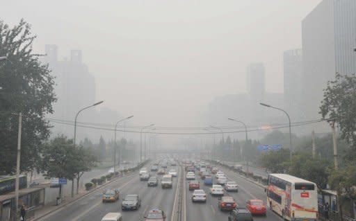Traffic makes its way through thick haze in Beijing in October 2011. Beijing's government on Friday bowed to a vocal online campaign for a change in the way air quality is measured in the Chinese capital, one of the world's most polluted cities