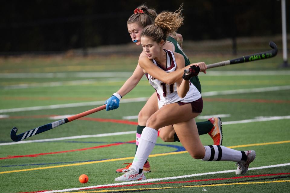 Algonquin's Lindsey Brown winds up to shoot as Nashoba's Kayla Flanagan defends during Monday's CMADA Class A field hockey quarterfinal in Northborough.