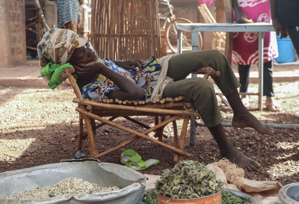 In this Wednesday, May 13, 2020, photo, a child sleeps at a market stall selling food in Tougan, Burkina Faso. Violence linked to Islamic extremists has spread to Burkina Faso's breadbasket region, pushing thousands of people toward hunger and threatening to cut off food aid for millions more. (AP Photo/Sam Mednick)