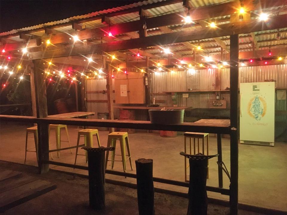 Outside bar with red, white, and yellow twinkling lights at night.