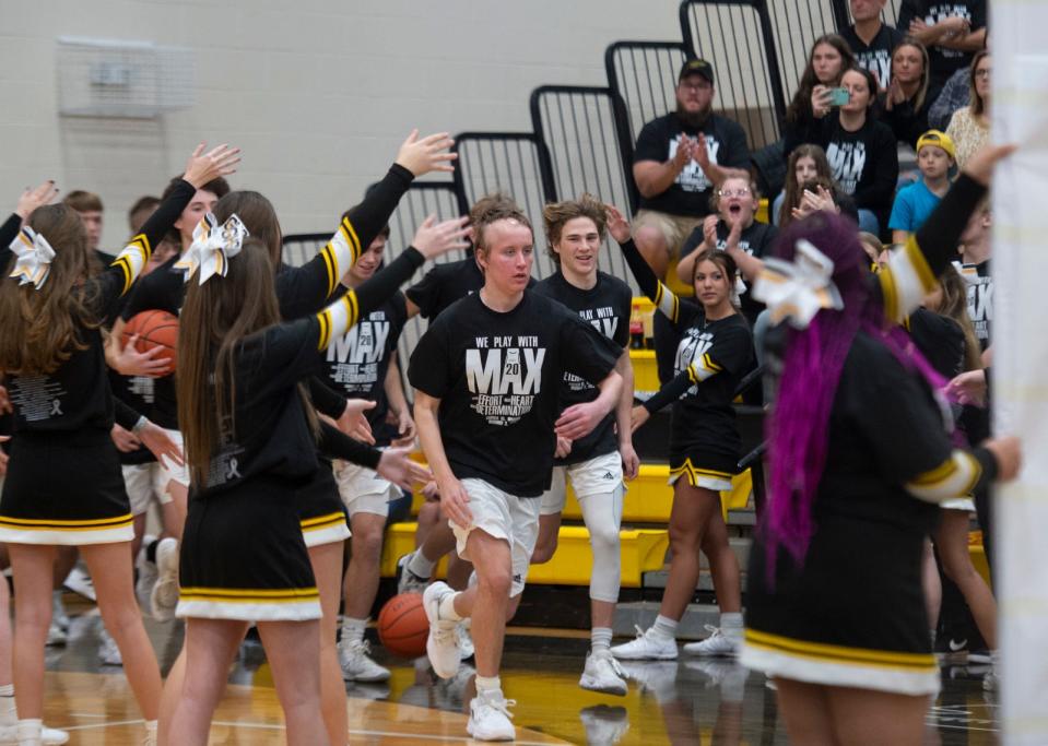 Garfield senior Max May leads the G-Men as they enter the court.