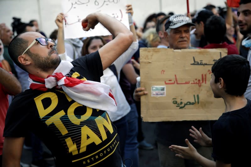 A protester throws a tomato towards Lebanon Central Bank at a demonstration during ongoing anti-government protests in Beirut