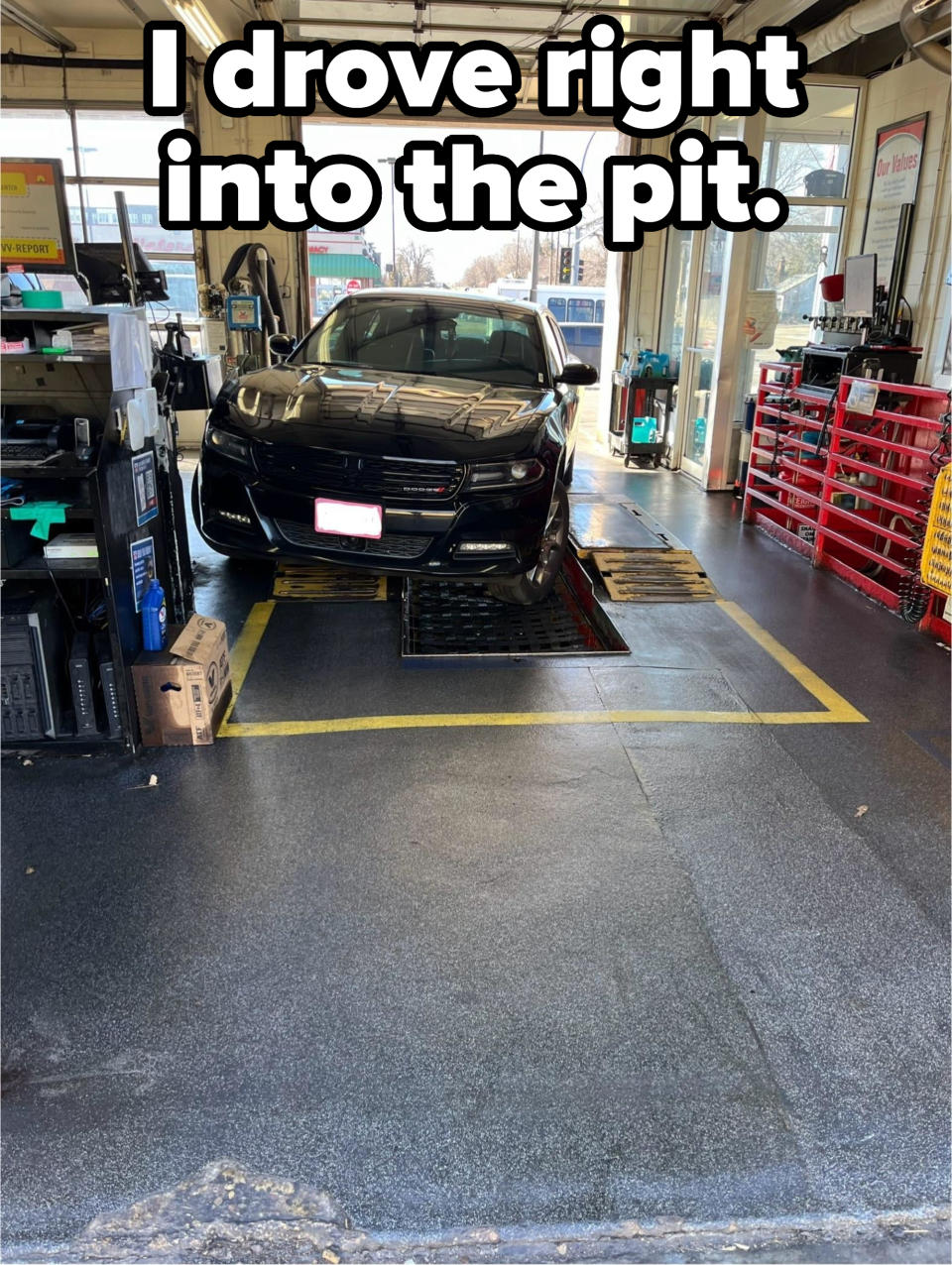 Car positioned on an auto service bay for maintenance or inspection