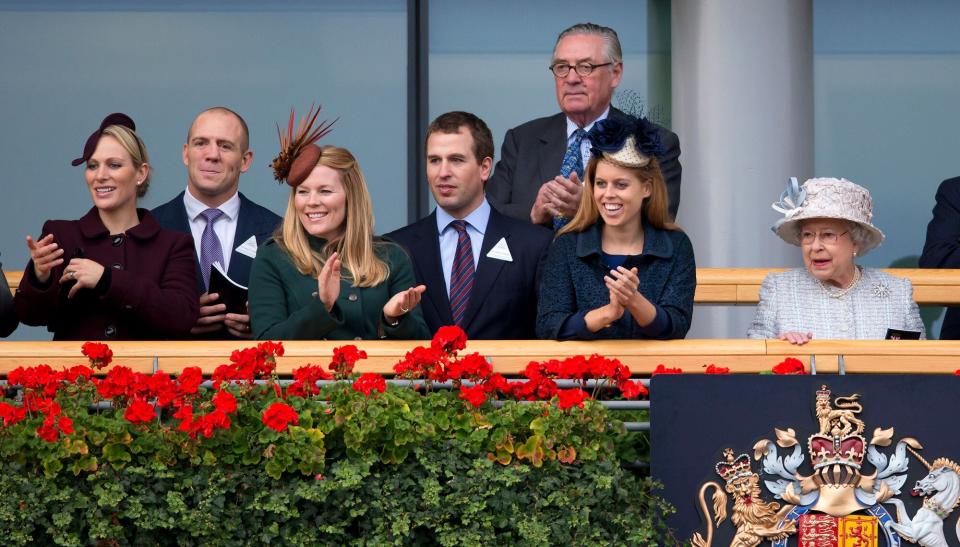 Zara Phillips, Mike Tindall, Autumn Phillips, Peter Phillips, Lord Vestey, Princess Beatrice and Queen Elizabeth II watch Frankel enter the winner's enclosure after winning The QIPCO Champion Stakes at the QIPCO British Champions Day meet at Ascot Racecourse on October 20, 2012 in Ascot, England.