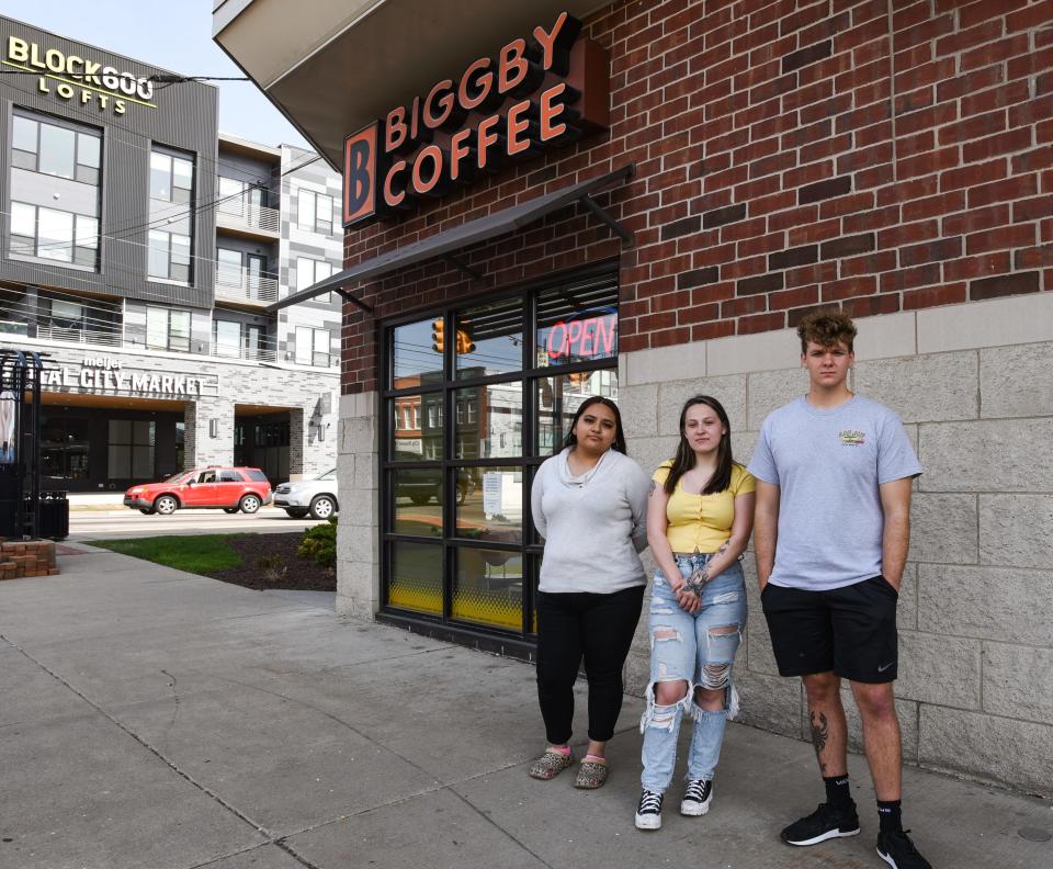 From left former Biggby Coffee assistant manager Jennifer Escobar, 20, former manager Morgan Kreck, 19, and former assistant manager Gavin Laviolette, 18, pose for a portrait Thursday, May 12, 2022, at the the 500 E. Michigan Ave. franchise location.  They and other workers quit their jobs Wednesday over workplace mistreatment allegations, citing verbal abuse and other instances of being disrespected by the local franchise owner and his associates.