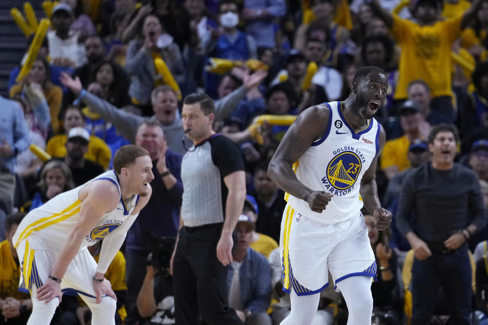 Golden State Warriors forward Draymond Green (23) reacts next to guard Donte DiVincenzo during the second half of Game 5 of the team's NBA basketball second-round playoff series against the Los Angeles Lakers on Wednesday, May 10, 2023, in San Francisco. (AP Photo/Godofredo A. Vásquez)