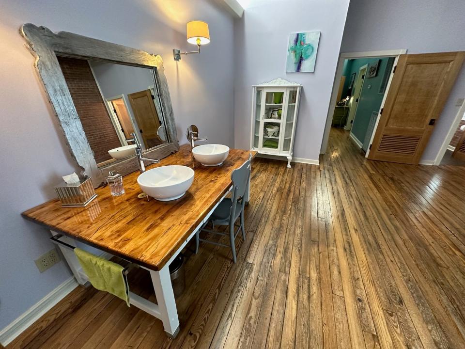 The vanity in the master bathroom of the Hurst Loft is a repurposed chemistry lab table. "You can still see the places where the gas jets were put in,” said Frances Hurst.