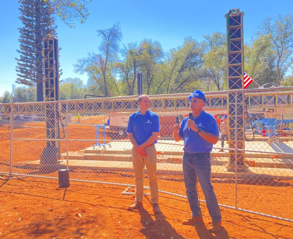 Matthew Gile, left, and Don Ajamian, both of Emergent 3D, talk about the 3D-printed house being built at Enterprise Community Park on Wednesday, Aug. 31, 2022.