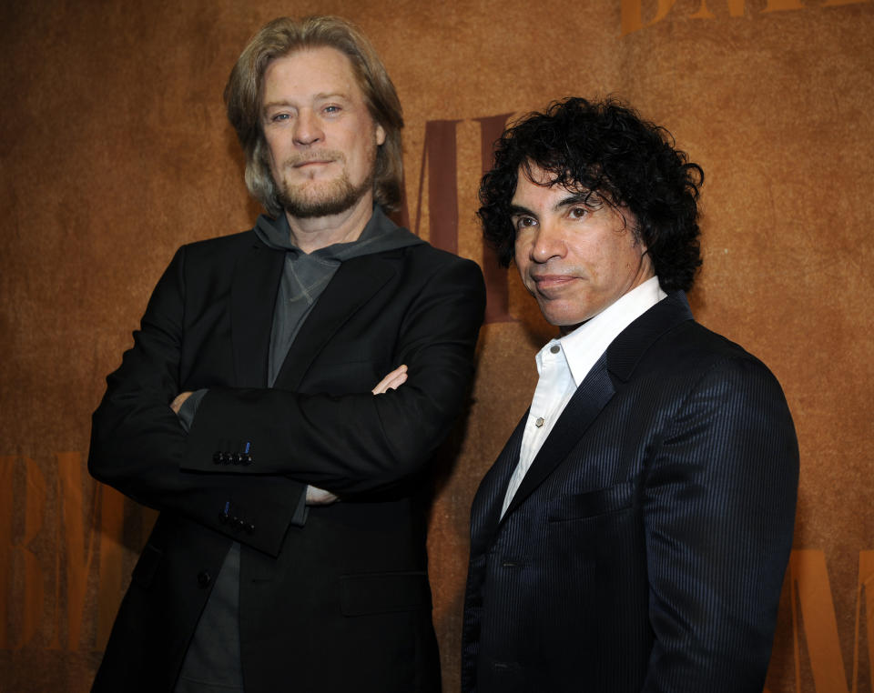 FILE - Daryl Hall, left, and John Oates pose before the 56th annual BMI Pop Awards in Beverly Hills, Calif. After more than a half-century of making music together, Hall is suing Oates over a proposed sale of his share of a Hall & Oates business partnership that Hall says he hasn't approved. A Nashville judge recently paused the sale of Oates' stake in Whole Oats Enterprises LLP to Primary Wave IP Investment Management LLC pending arbitration, or until Feb. 17, 2024. (AP Photo/Chris Pizzello, File)